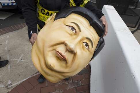 A protester holds a Xi Jinping mask outside the security perimeter near the Walter E. Washington Convention Centre during the Nuclear Security Summit in Washington, DC. Photo: EPA