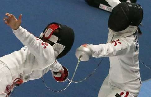 Hong Kong's Kong Man-wai (right) has qualified in the women’s sabre by virtue of her Olympic qualification ranking. Photo: Nora Tam