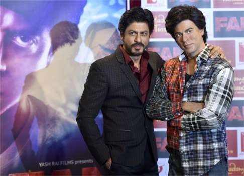 Shah poses with a wax model of himself.