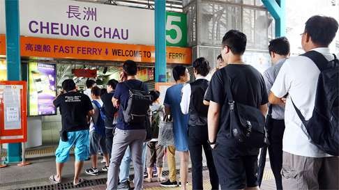 Passengers queue for an island ferry at Central Pier. Photo: Edmond So