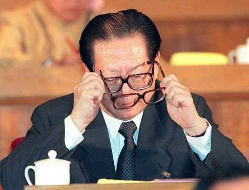 A look back at 1997. Chinese President Jiang Zemin changes his eye glasses as he reads along with Premier Li Peng's work report at the start of the annual meeting of the National People's Congress on March 1, 1997 in the Great Hall of the People. Photo: AFP