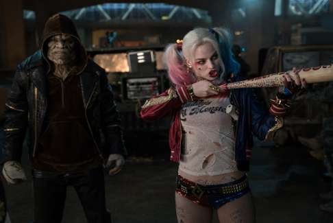 Harley Quinn aims her baseball bat like a rifle in a scene from Suicide Squad while partner in crime Killer Croc, played by Adewale Akinnuoye-Agbaje, looks on. Photo: Clay Enos