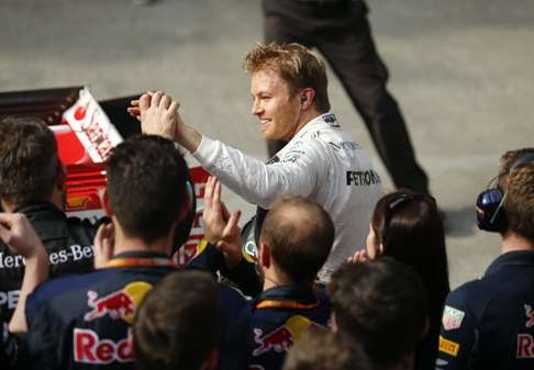 Mercedes’ Nico Rosberg is congratulated by his team after securing a third win of the season. Photo: EPA