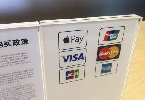 A display explaining purchases can be made using Apple Pay, as well as other formats, at an Apple store in Shanghai, China. Photo: AFP