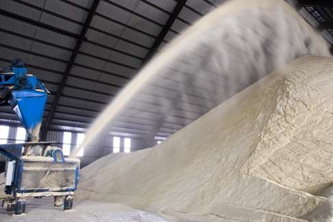 Raw sugar is blown into a warehouse at the St Mary Sugar Co-Op Mill near Franklin, Louisiana during a sugar cane harvest. Photo: Corbis