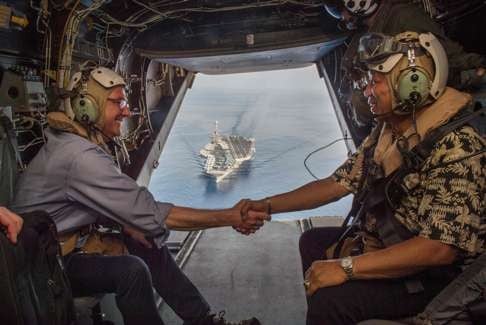 US Secretary of Defence Ashton Carter (left) and Philippine Secretary of National Defence Voltaire Gazmin shake hands on a Marine Corps V-22 Osprey as they leave the USS Stennis after touring the aircraft carrier in the South China Sea. Photo: AFP/US Department of Defence