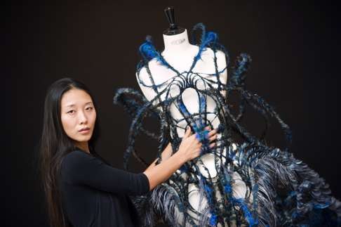 Chinese designer Yiqing Yin poses with one of her creations at Paris fashion week in September 2012. Photo: AFP