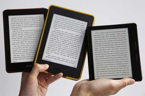 The Kindle Oasis (far right) is shown next to two earlier Kindle models, the Voyage (left) and the Paperwhite (centre). Photo: AP