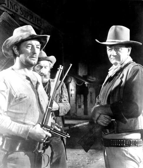 John Wayne (right), Robert Mitchum (left) and Arthur Hunnicutt lay plans to smoke out some entrenched badmen in this scene from Howard Hawks’ film El Dorado. Hollywood falsely portrayed the Wild West as overwhelmingly white.
