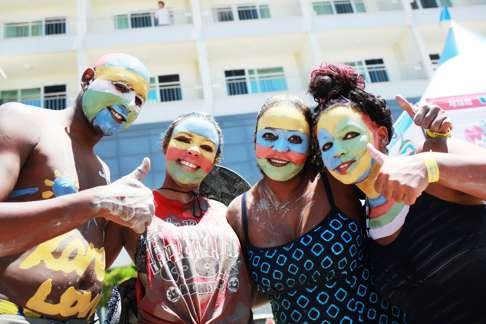 Face-painted revellers give a thumbs-up to the fun at last year’s event.