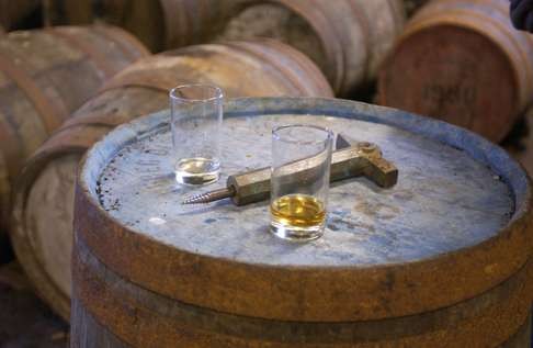 Sampling Ardbeg from barrels maturing in the bonded warehouse on Islay. Photo: Alamy