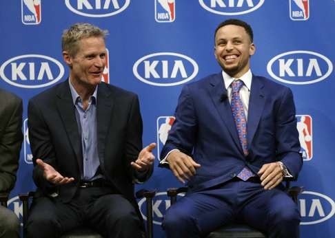 Stephen Curry and Warriors head coach Steve Kerr share a joke during the award ceremony. Photo: AP