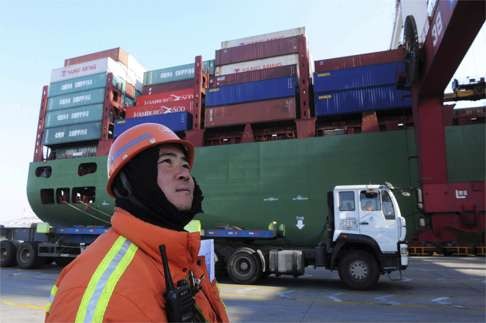 A worker stands near a container ship at a port in Qingdao, Shandong province. Trump wants to slap a 45 per cent tariff on Chinese imports. Photo: AP