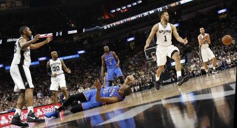 The Thunder’s Kevin Durant (lying on floor) watches the ball get away from him. Photo: AFP
