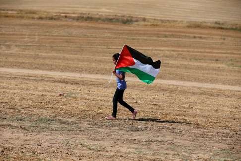 An Arab-Israeli girl holds a Palestinian flag as she marches for the right of return for Palestinian refugees who fled their homes or were expelled during the 1948 war that followed the creation of the state of Israel, near the southern Israeli Bedouin of Rahat. Photo: AFP