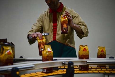 A factory worker on the packaging line at Delta. Photo: AFP