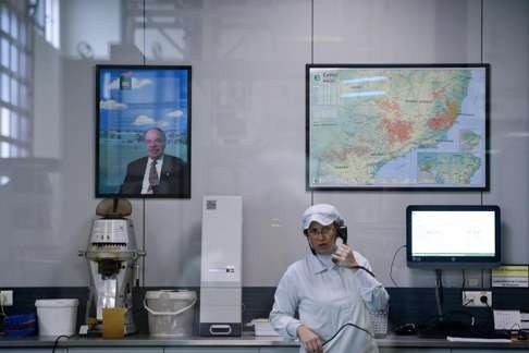 Images of Nabeiro are ubiquitous in Campo Maior, like on the wall behind this lab worker at Delta. Photo: AFP