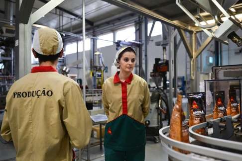 Two factory workers on the production line at the Delta coffee factory in Campo Maior. Photo: AFP