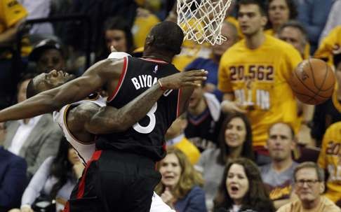 LeBron James is fouled hard by Raptors centre Bismack Biyombo. Photo: EPA