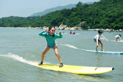 A young girl learns to surf.