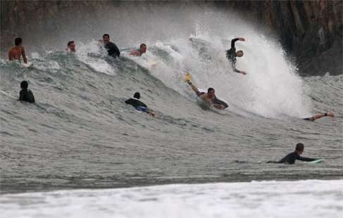 Surfers make the most of heavy seas in Big Wave Bay in the face of a severe typhoon moving closer to Hong Kong.