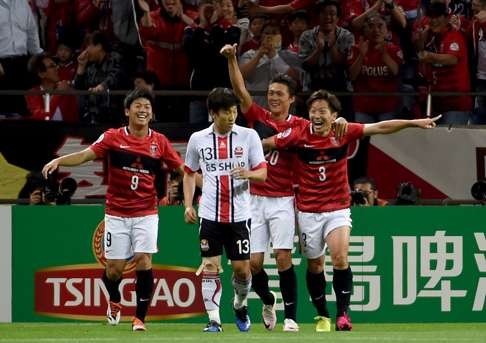 Urawa Reds’ Tomoya Ugajin (right) celebrates his goal with teammates Yuki Muto (left) and Tadanori Lee behind FC Seoul’s Go Yo-han (2nd L). Photo: AFP