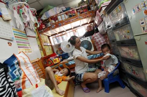 A family in a subdivided home. Splitting up a flat into several cubicles and renting each out to entire families is common practice in Hong Kong. Photo: David Wong