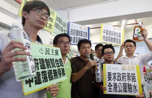 Members of the Democratic Party and Labour Party protest while Chief Secretary Carrie Lam attends a special meeting on the water scandal. Photo: K. Y. Cheng