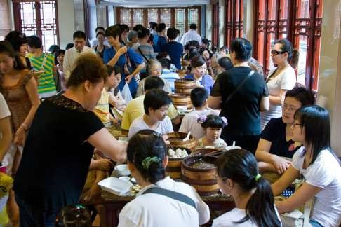 Diners eat dumplings at a Shanghai restaurant. Photo: Alamy