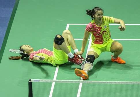 Tian Qing (right) and Zhao Yunlei of China collapse on court in delight after winning their doubles match that sealed China’s win against the South Koreans. Photo: Xinhua