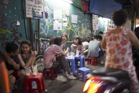 People stop for a coffee on the streets of Ho Chi Minh.