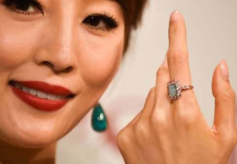 A model presents a 5.03-carat green diamond ring at a media preview of Christie's Hong Kong 2016 spring auction in Hong Kong. The antique collecting and the artwork auction market are thriving in the city. Photo: Xinhua