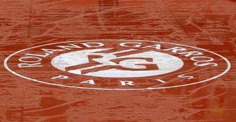 Puddles of rain water lie on the cover of Court Philippe Chatrier. Photo: AP