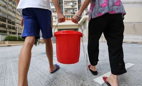 Residents collect fresh water last August at one of the temporary distribution points at an estate in Hung Hom, one of a number where tap water was found to have excessive levels of lead. Photo: Sam Tsang