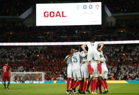 England players celebrate Smalling’s goal. Photo: AFP