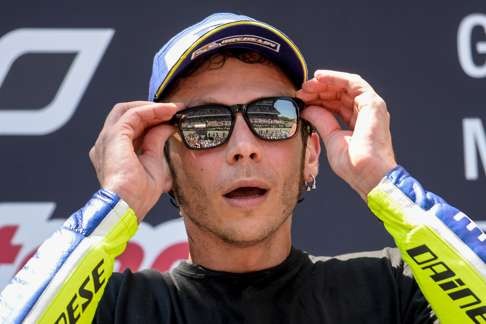 Valentino Rossi adjusts his sunglasses on the podium. Photo: AFP