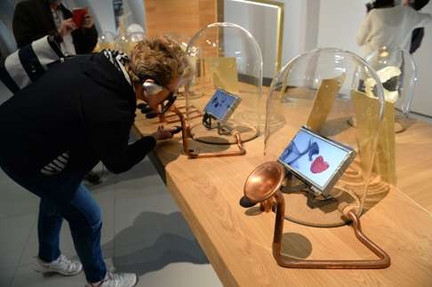 A woman takes part in a sensory exhibit at La Cite du Vin.