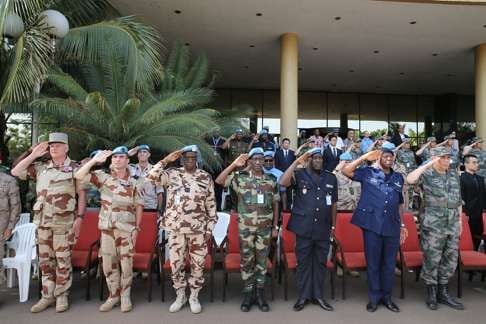 Officers salute during the memorial ceremony held for Chinese peacekeeper Shen Liangliang in Bamako on Tuesday. Photo: Xinhua