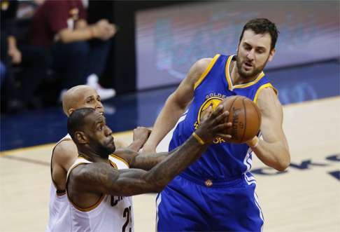 James steals the ball from Warriors centre Andrew Bogut during game thee. Photo: AFP