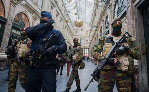 In this November 2015 file photo, a police officer and soldiers stand guard inside the Galerie de la Reine following an elevated terror level in Brussels. Photo: EPA