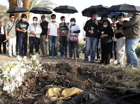 Family members of the victims attend a mourning ceremony at the crash site. Photo: Sam Tsang
