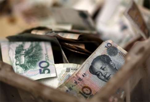 Chinese banknotes lie in a vendor’s cash box at a market in Beijing. Photo: REUTERS