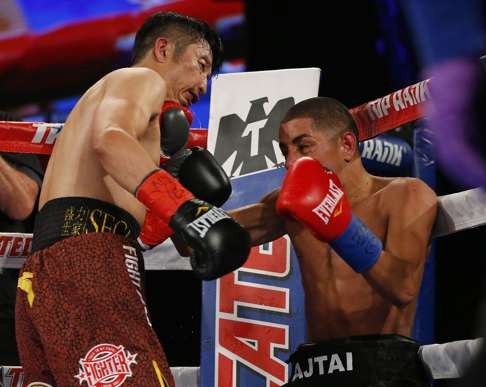 Zou Shiming is hit by a left from Jozsef Ajtai. Photo: AFP
