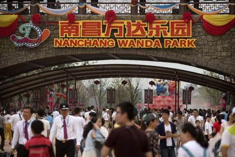 People walk through the entrance to the Wanda City theme park in Nanchang in late May. Photo: AP