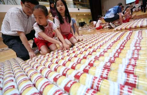 Parents, teachers and students from Singapore International School in Hong Kong use canned food to create an 