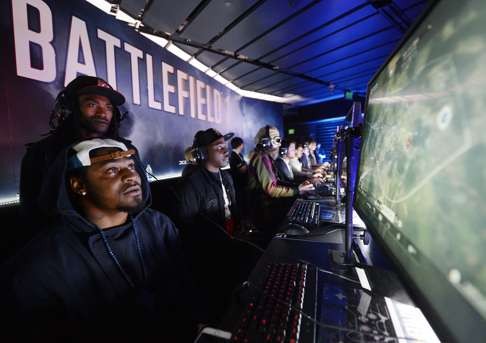 American football player Marshawn Lynch plays the video game Battlefield 1 after an Electronics Arts news conference in Los Angeles ahead of E3, which opens on Tuesday. Photo: AFP