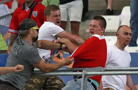 Russian supporters attack an England fan at the end of the group B soccer match. Photo: AP