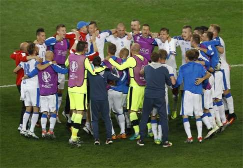 Slovakia's players and team members celebrate. (AP Photo/Darko Vojinovic)