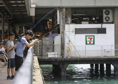 Anglers at North Point Ferry Pier try to catch the released fish.