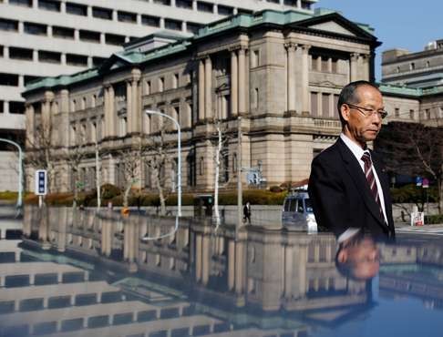 A man walks past the Bank of Japan building in Tokyo. Photo: Reuters